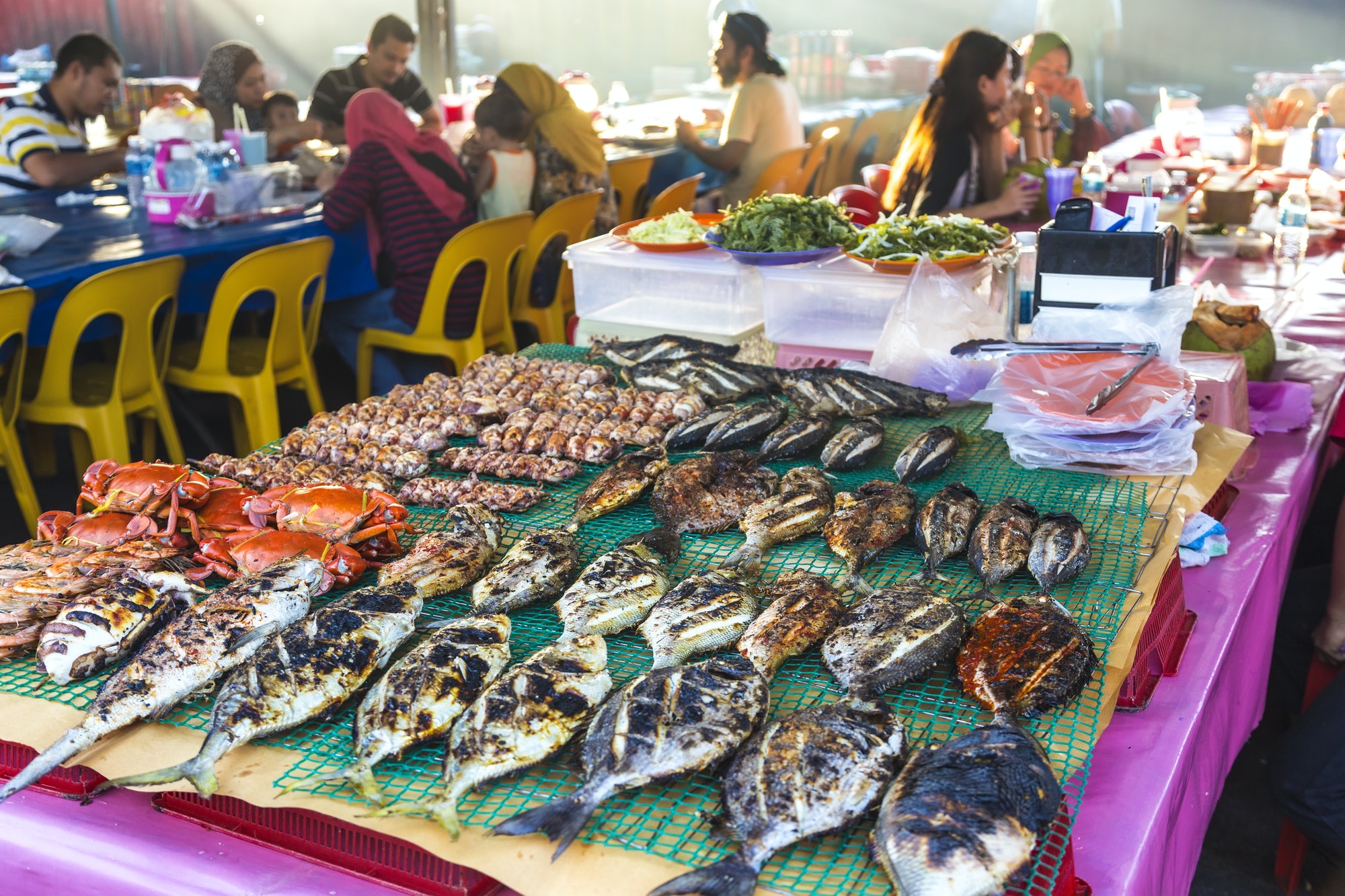 Grilled fish on a table at a food market restaurant